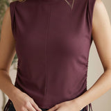 graced Cinch Side Top in winetasting ribbed cotton with side tie detail and sleeveless silhouette on a smiling model