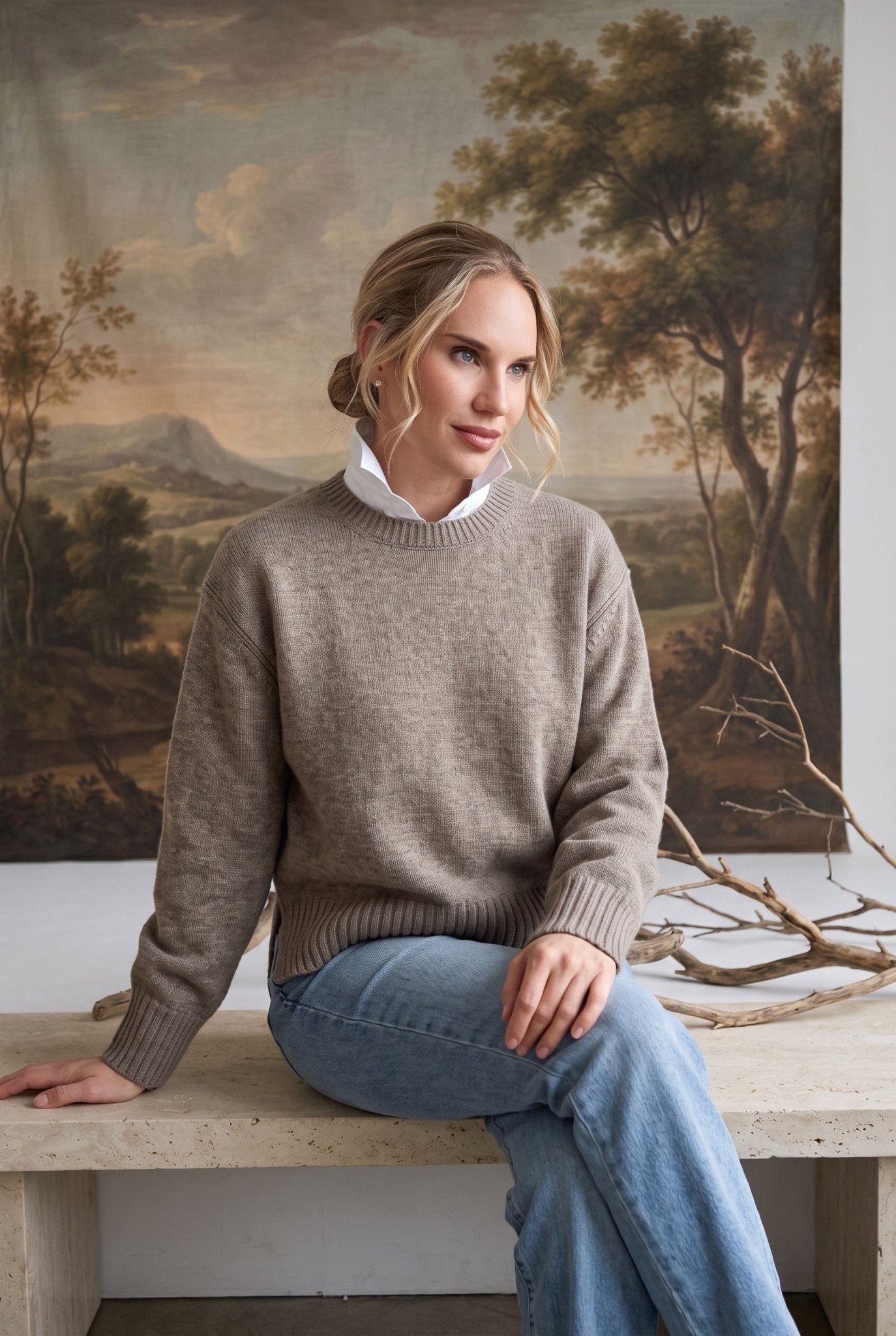 graced crew neck sweater in taupe worn by a woman with a white collared shirt underneath and light blue jeans
