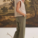 graced The Darcy wide-leg pants in dark olive with pocket detail, worn by a blonde model in a beige sleeveless top.