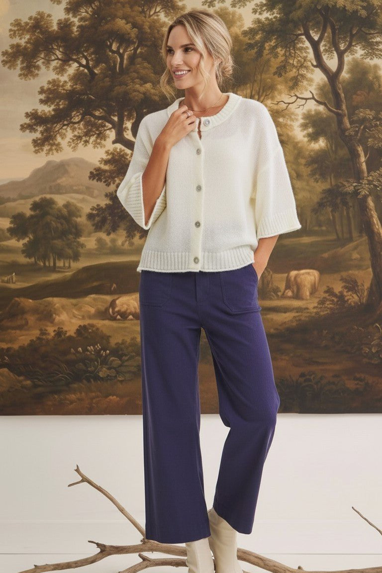 Model wearing graced The Darcy navy wide-leg pants with pocket detail and a cream button-down knit cardigan