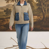 graced The Dolly taupe sweater jacket with denim collar and pocket details worn by a woman with blue jeans