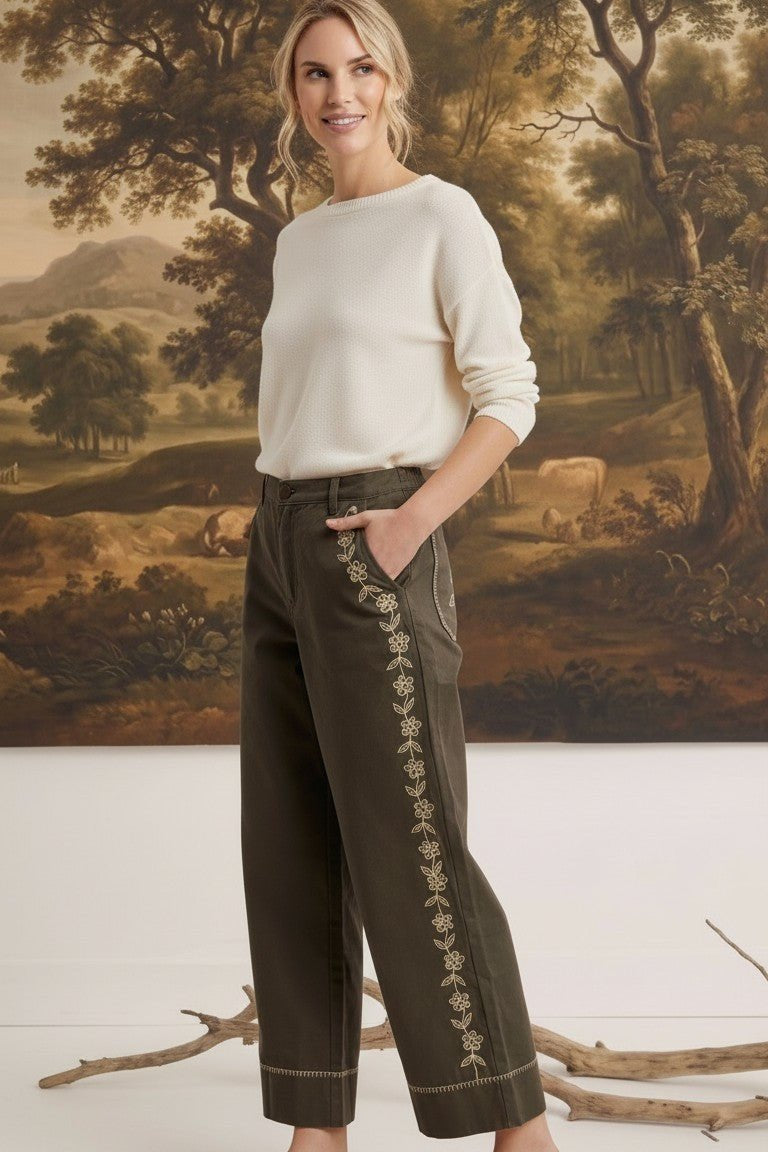 graced Eden wide-leg pants in olive green cotton with floral embroidery, worn by a model with a cream sweater