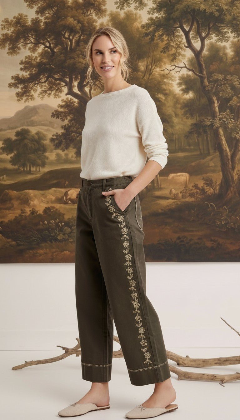 graced Eden wide-leg pants in olive green cotton with floral embroidery, worn by a model with a cream sweater