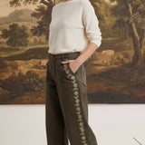 graced Eden wide-leg pants in olive green cotton with floral embroidery, worn by a model with a cream sweater