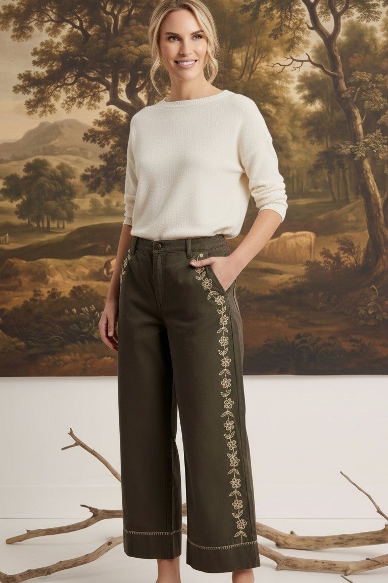 graced Eden wide leg pants in olive green cotton with delicate floral embroidery, paired with a cream sweater