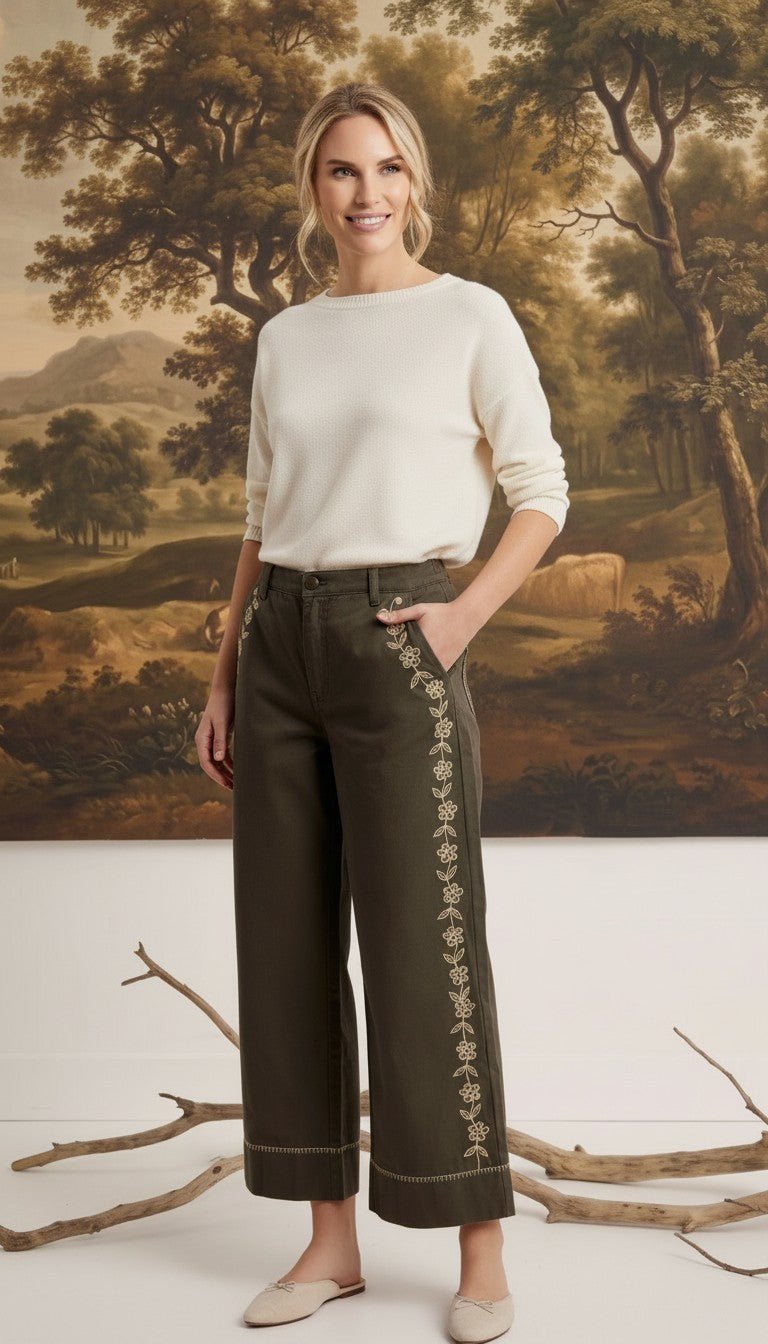 graced Eden wide leg pants in olive green cotton with delicate floral embroidery, paired with a cream sweater