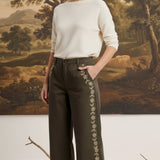 graced Eden wide leg pants in olive green cotton with delicate floral embroidery, paired with a cream sweater