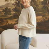 graced Eloise ivory crew neck sweater with dropped shoulders and ribbed hem worn with blue jeans