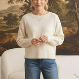 graced Eloise ivory crew neck sweater with dropped shoulders and wide ribbed hem worn with blue denim jeans