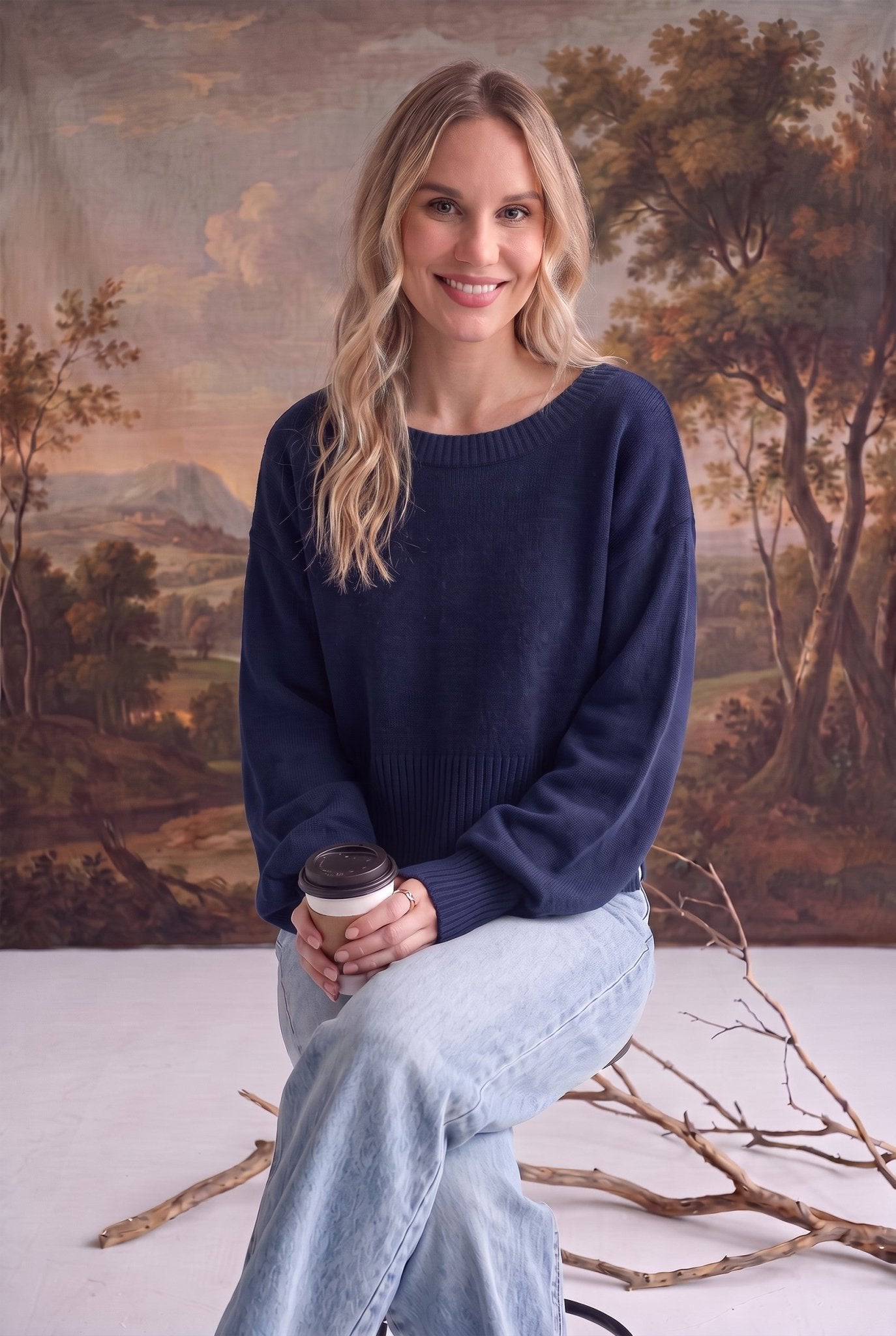 graced Eloise navy crew neck sweater with dropped shoulders and ribbed hem worn by a woman with light denim jeans
