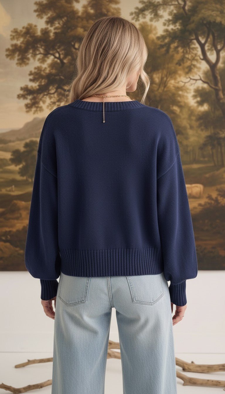 graced Eloise navy crew neck sweater with dropped shoulders and wide ribbed hem worn with light wash jeans