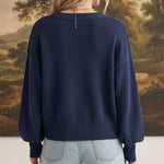 graced Eloise navy crew neck sweater with dropped shoulders and wide ribbed hem worn with light wash jeans