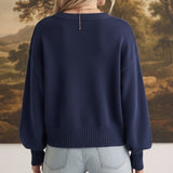 graced Eloise navy crew neck sweater with dropped shoulders and wide ribbed hem worn with light wash jeans