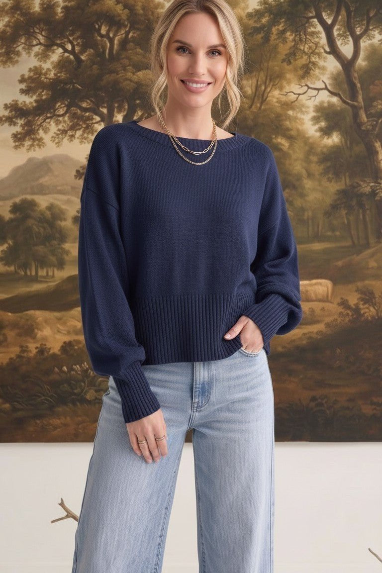 graced Eloise navy crew neck sweater with dropped shoulders and ribbed hem worn by a woman with light blue jeans