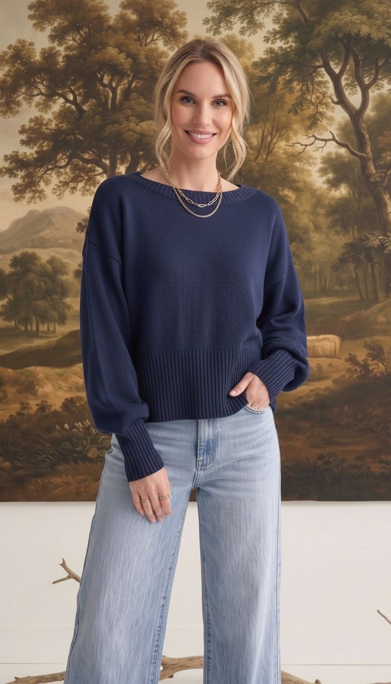 graced Eloise navy crew neck sweater with dropped shoulders and ribbed hem worn by a woman with light blue jeans