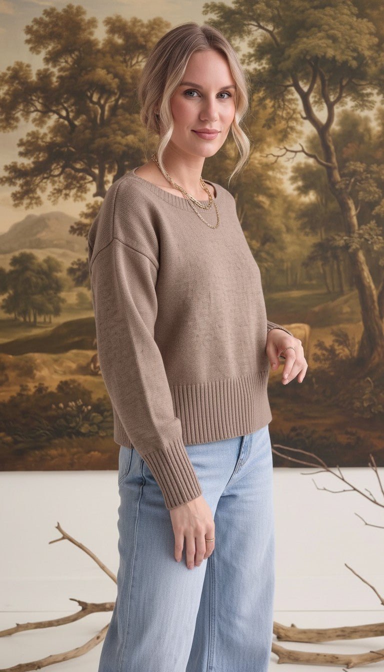 graced Eloise taupe crew neck sweater with drop shoulders and wide ribbed hem worn by a woman with light blue jeans