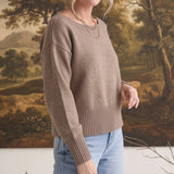 graced Eloise taupe crew neck sweater with drop shoulders and wide ribbed hem worn by a woman with light blue jeans