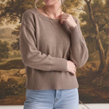 Model wearing a taupe graced Eloise crew neck sweater with drop shoulders and wide ribbed cuffs and hem.