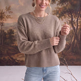 graced Eloise taupe crew neck sweater with drop shoulders and ribbed cuffs worn by a woman with light blue jeans