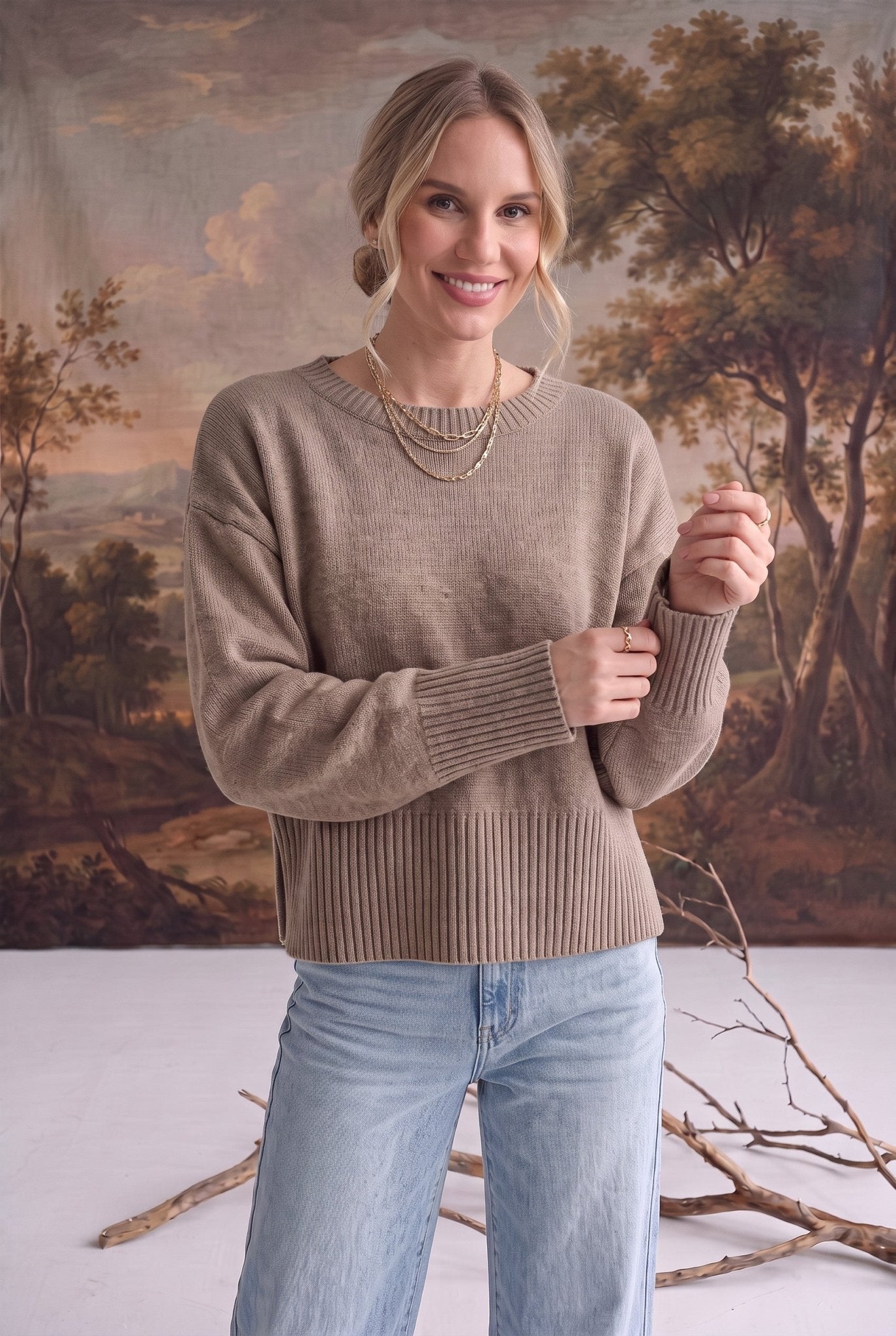 graced Eloise taupe crew neck sweater with drop shoulders and ribbed cuffs worn by a woman with light blue jeans