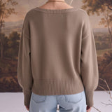 Back view of a woman wearing a graced taupe Eloise crew neck sweater with drop shoulders and wide ribbed hem.