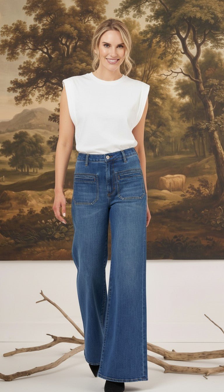 graced Emerson patch pocket relaxed flare jeans in medium wash denim worn with a white sleeveless top