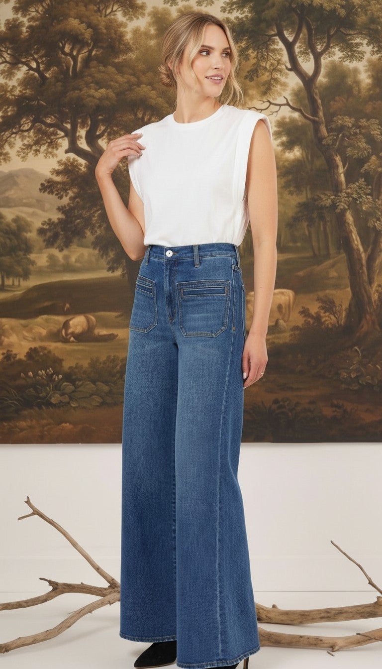 Model wearing graced Emerson relaxed flare jeans with patch pockets and a white sleeveless top