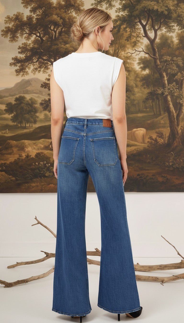graced Emerson relaxed flare jeans with patch pockets in medium wash denim worn by a model from the back view