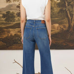 graced Emerson relaxed flare jeans with patch pockets in medium wash denim worn by a model from the back view