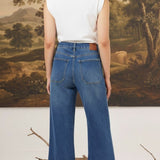 graced Emerson relaxed flare jeans with patch pockets in medium wash denim worn by a model from the back view