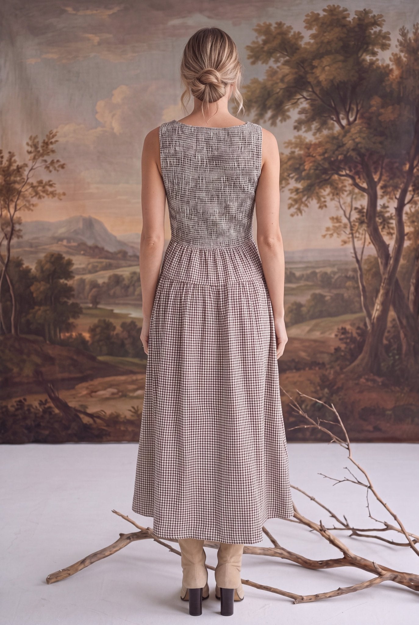 Back view of a graced Harper smocked gingham midi dress in brown and white, featuring a fitted bodice and midi length.