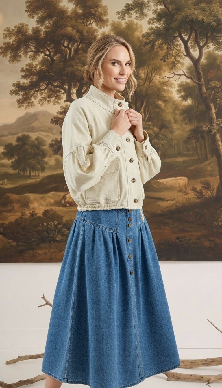 graced cream cotton blend jacket with balloon sleeves worn by a model in front of a landscape painting