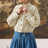 graced Jaden cream cotton jacket with balloon sleeves and button-up front worn by a woman with a denim skirt
