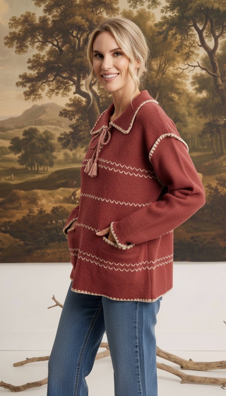 graced Jenna Whipstitch Sweater in rust red with contrast embroidery, collar, and pockets worn by a smiling model