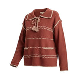 graced Jenna Whipstitch Sweater in rust red with cream contrast embroidery, collar, tassel tie, and front pockets.