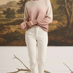 graced The Joan Gradient Sweater in soft pink and cream, worn by a model with white jeans in a studio setting.