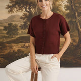 Model wearing a burgundy graced Jocelyn button-up knit top with short sleeves and a round neckline