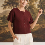 graced Jocelyn button up knit top in deep burgundy with a round neckline and short sleeves on a smiling model