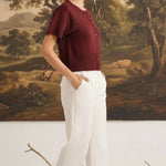 graced Jocelyn button up knit top in burgundy with short sleeves and a round neck, worn with white trousers