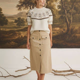 graced The Josephine Faire Isle Top in cream with brown knit pattern, short sleeves, and round neck on a model.