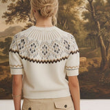 Back view of a woman wearing the graced Josephine Faire Isle Top, a cream short-sleeve knit with a brown geometric pattern