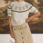 Model wearing graced The Josephine Faire Isle Top, a cream short-sleeve knit with a brown and black patterned yoke.