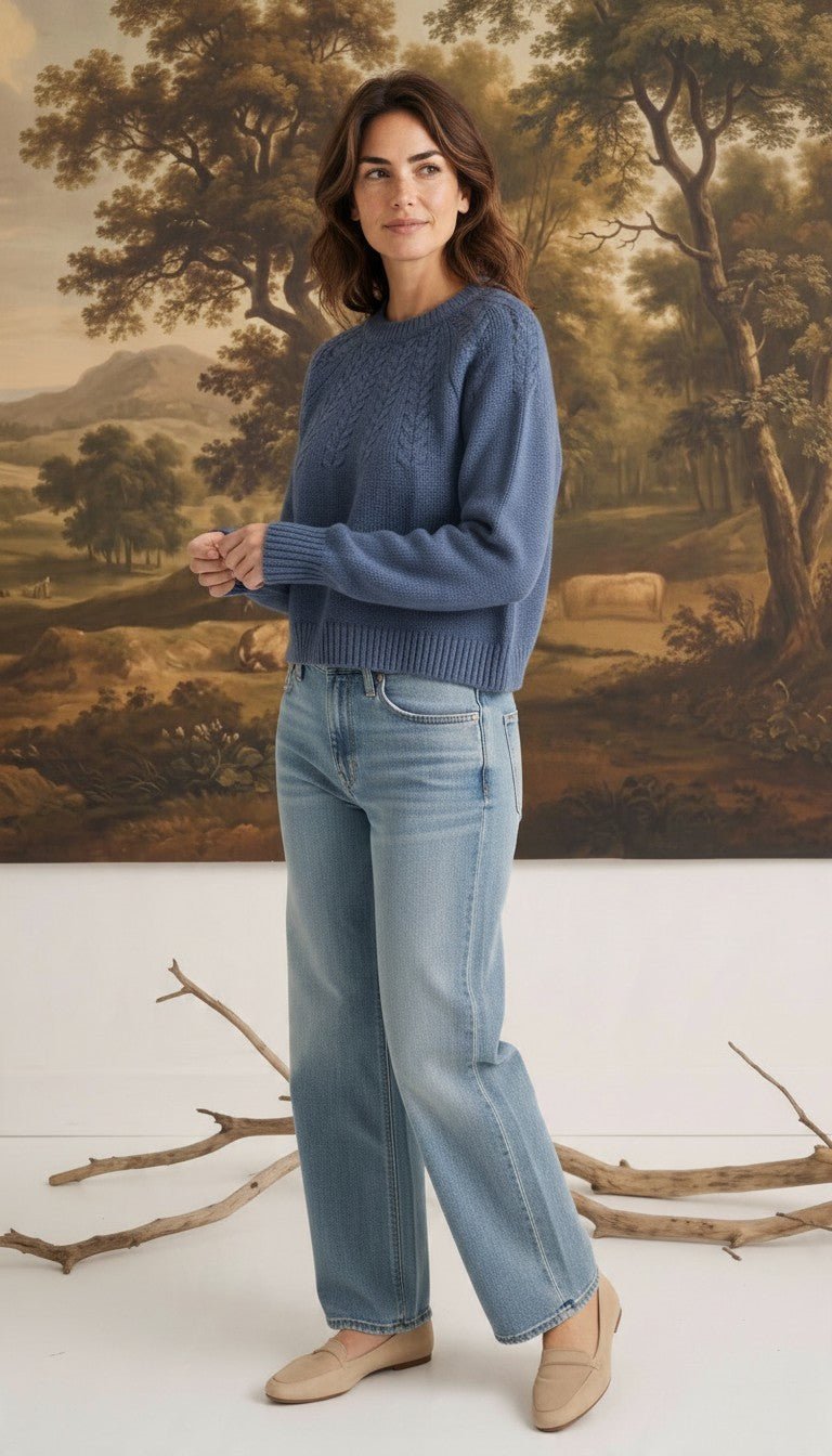 Model wearing a graced denim blue sailor-inspired knit sweater with a round neck and relaxed fit