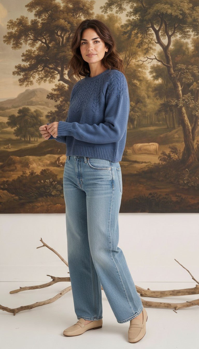 graced The Kaitlyn Sailor Sweater in denim blue with a round neck and knit texture, worn by a model with jeans.