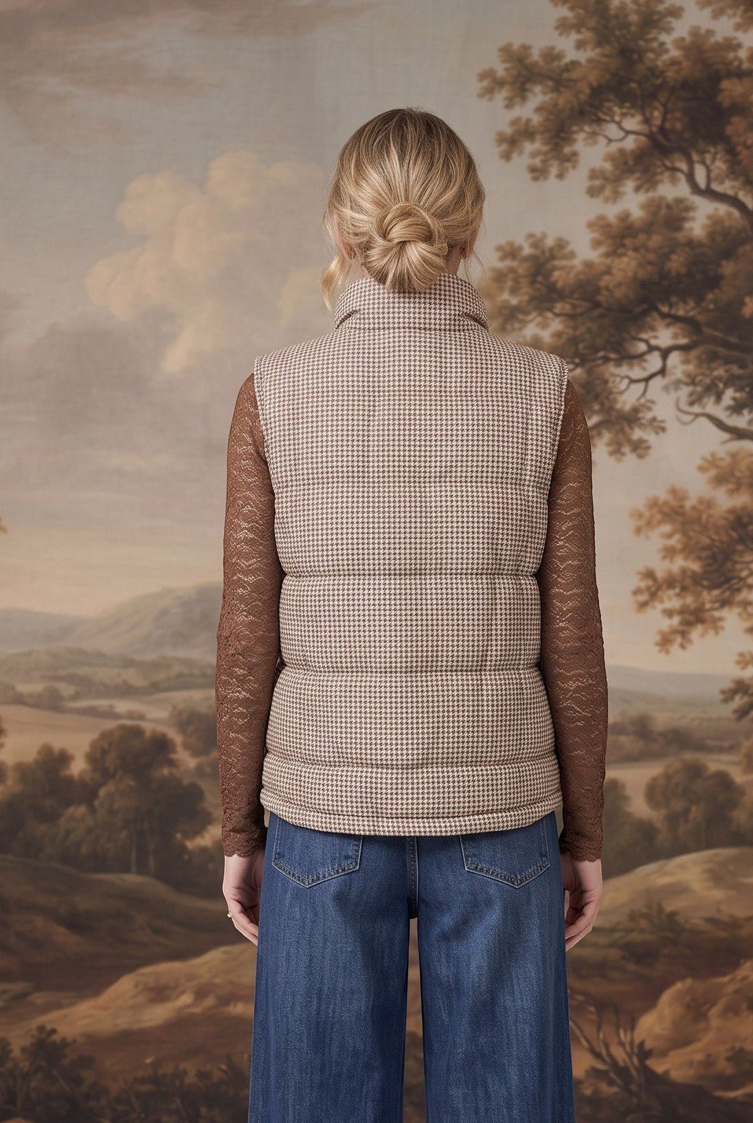graced Karla Gingham Vest in brown and white worn over a brown lace long-sleeve top and blue jeans, back view