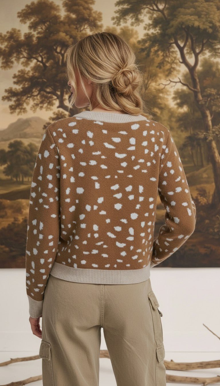 Back view of a woman wearing a graced Kathy brown knit sweater with a white deer pattern and ribbed trim