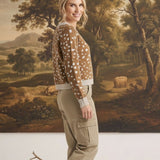 graced Kathy sweater in brown with white deer pattern, worn by a woman with khaki cargo pants and beige loafers