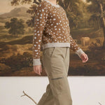 graced Kathy sweater in brown with white deer pattern, cotton-blend knit worn by a model with khaki cargo pants