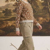 graced Kathy sweater in brown with white deer pattern, cotton-blend knit worn by a model with khaki cargo pants