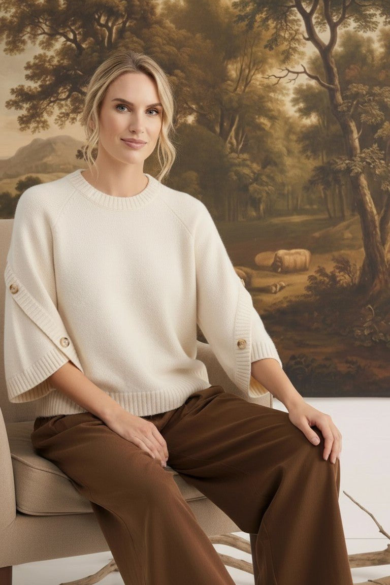 graced The Layla cream knit top with button-detailed sleeves, worn by a model in a relaxed fit.